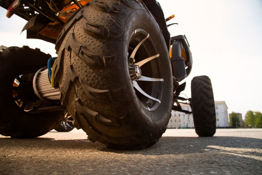 An ATV sits parked on a public road.